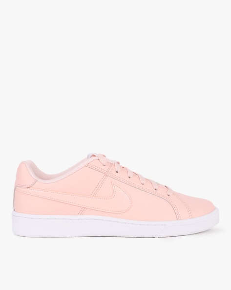 Sneakers and sports accessories trending color of year 2024 Peach Fuzz.  Stock Photo by tkasperova