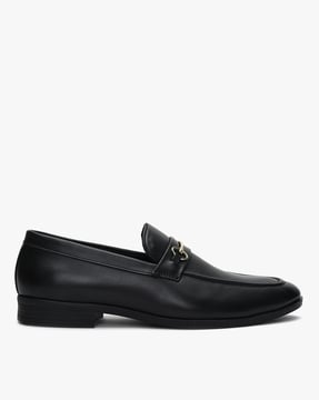 black dress shoes with gold accents