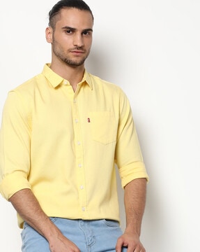 Yellow shirt and light cheap blue jeans