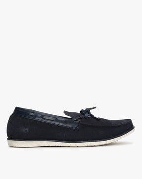 white slip on boat shoes