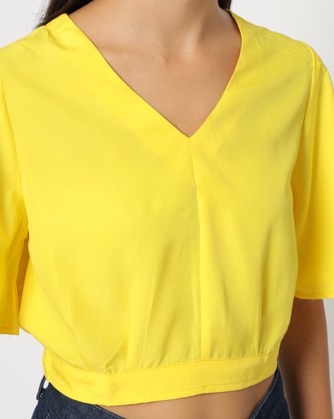 V-neck crop top with bell sleeves.