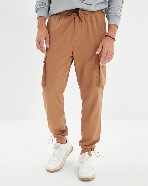 ASOS DESIGN tapered cargo pants in light brown with toggles | ASOS