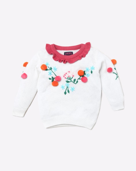white sweater with pom poms