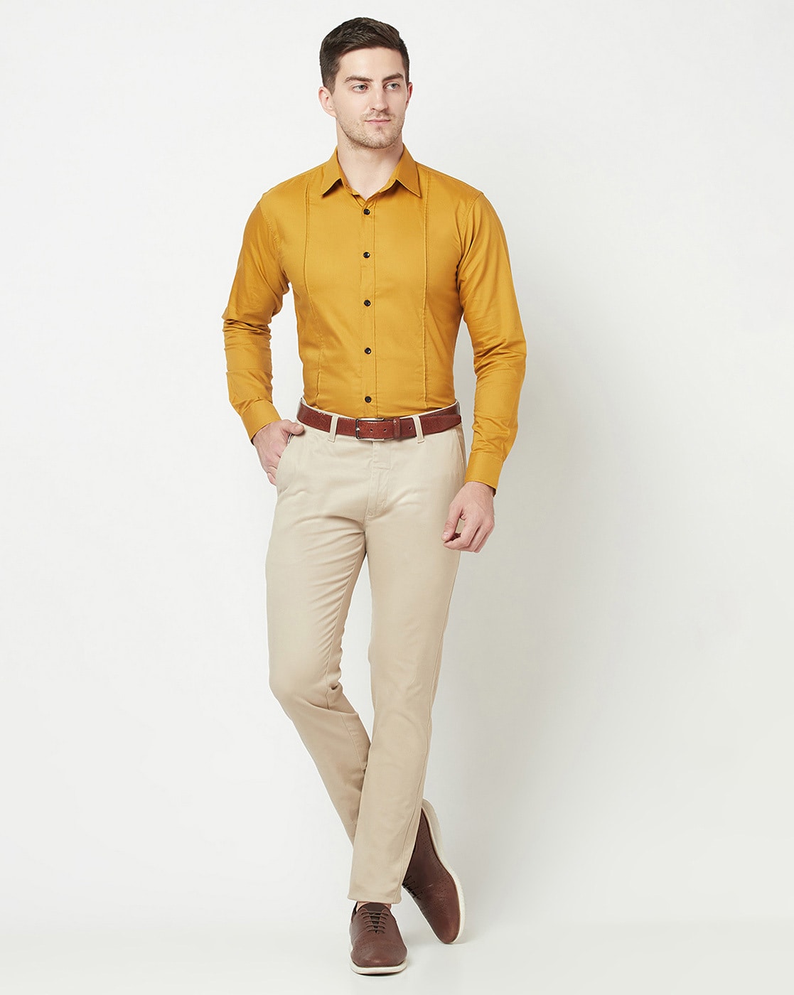 Man in stylish combination of brown corduroy pants and yellow dress shirt  on Craiyon