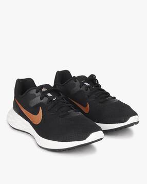 black and gold nike runners