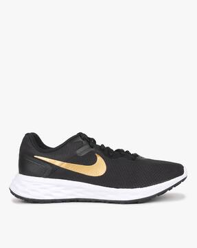 black and yellow nike boots