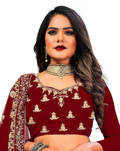 Photo of A pictures of a bride in maroon lehenga and beautiful jewellery.