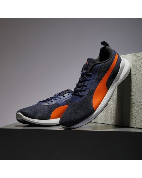 navy blue and orange pumas