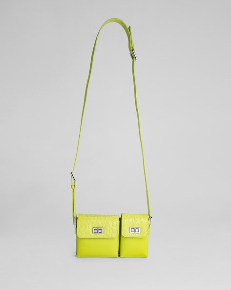 Nylon crossbody bag in neon green. Mini model with zip fastener, flat  interior pocket and chain strap. Exterior customized with Chimo logo. This  model contains 100% Recycled polyester + 100% Recycled polyamide.