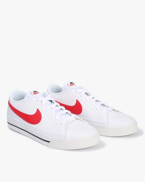 White nike trainers with cheap red tick