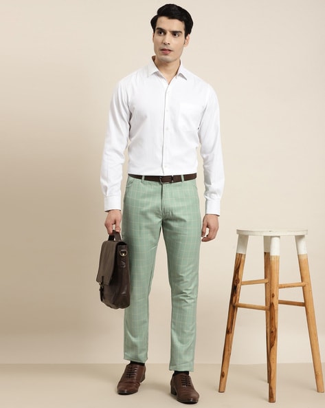 Woman in white shirt and green pants standing near black chair photo – Free  Alochol Image on Unsplash