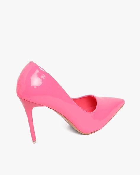 pink high heel shoes green background