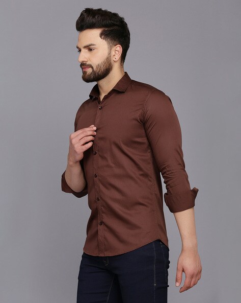 brown shirt and black pants