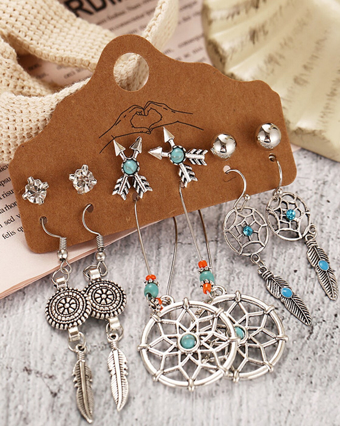 Premium Photo  Earrings of handmade dream catcher with feathers threads  and beads rope hanging