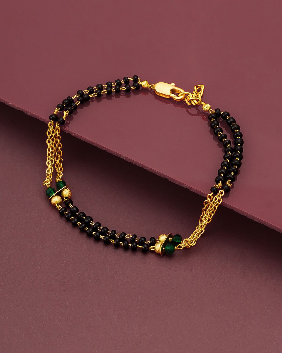 gold bracelet with black stone