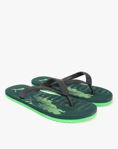 Puma black and on sale green flip flops