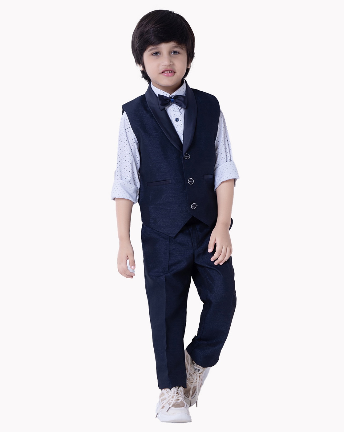 Portrait of 8 year old boy dressed in a suit for a special event or  occasion like wedding or communion isolated on gray background Stock Photo  - Alamy