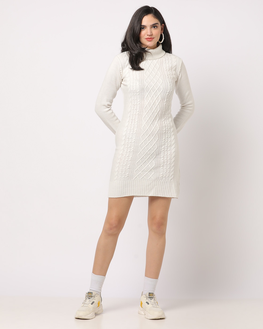 Sexy young female wearing a white sweater dress with black long boots Stock  Photo by wirestock