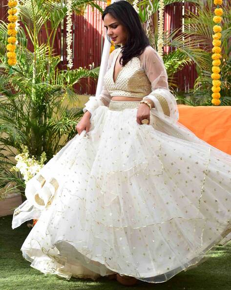 CREAM WHITE BANARASI GOTA WORK LEHENGA SET WITH A HAND EMBROIDERED MIRROR  WORK BLOUSE PAIRED WITH A MATCHING RUFFLED DUPATTA AND GOLD DETAILS. -  Seasons India