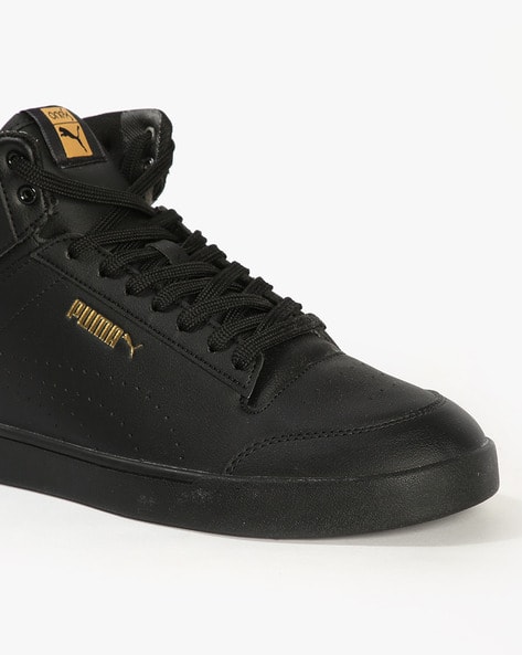 gold and white high top pumas