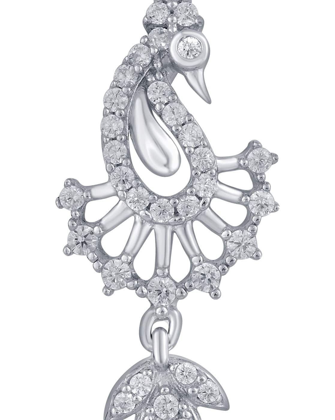 Glistening silver earrings catching the light