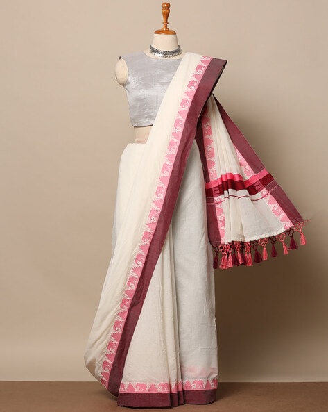 Cream kerala saree with zari buttas on its body, zari border & pallu  features peacock designs