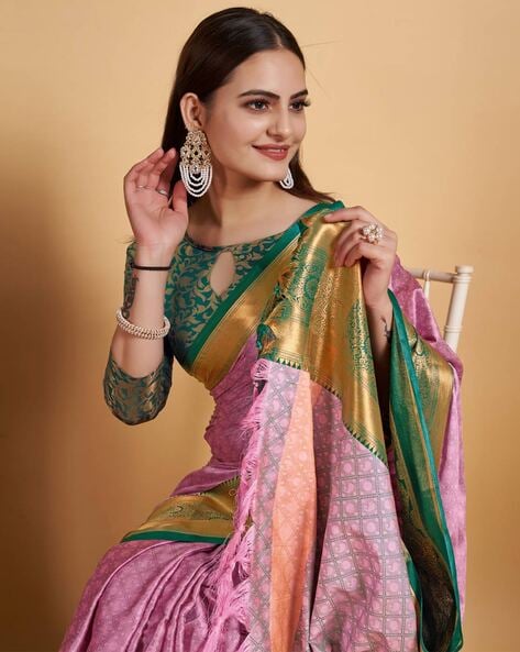 Photo of South Indian bride wearing a green and pink saree with temple  jewellery.