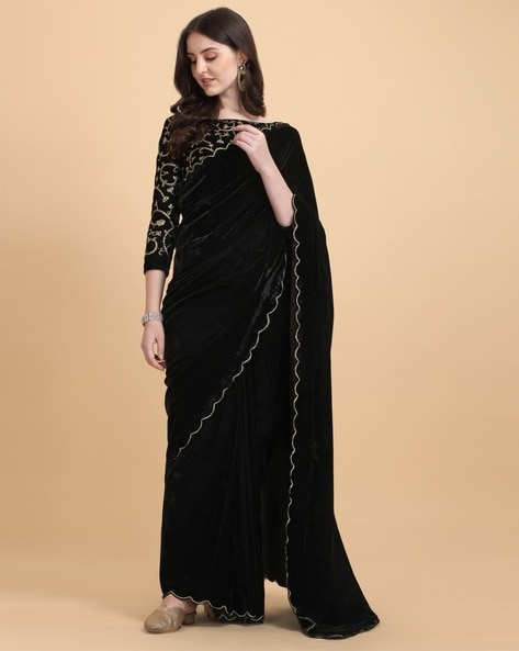 In a black color saree and velvet off shoulder full sleeve blouse design