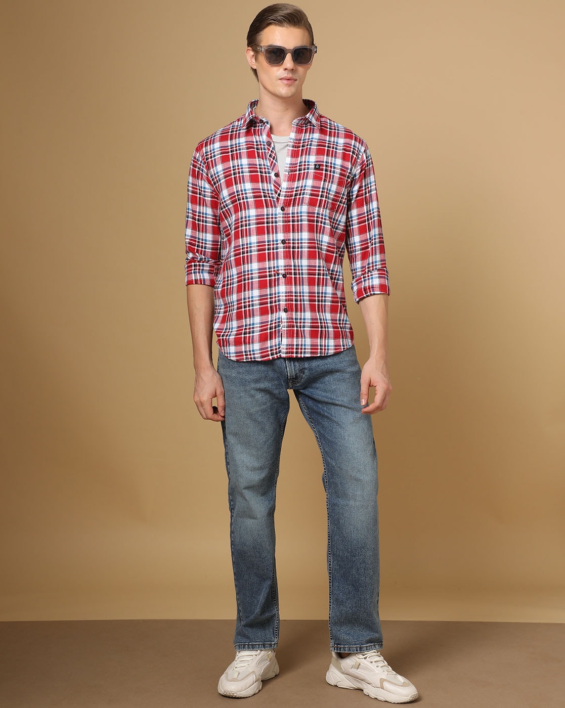 Man in Blue and White Plaid Shirt and Denim Jeans Standing on