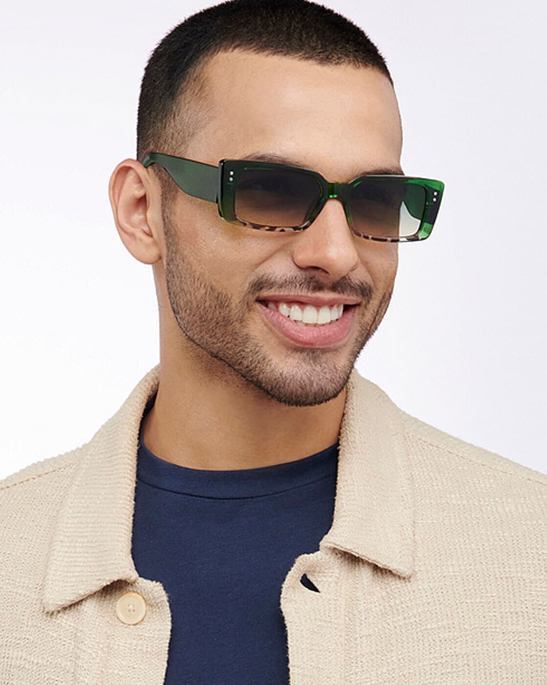 a young boy with a white buzz cut hairstyle and wearing red octagonal  shaped sunglasses