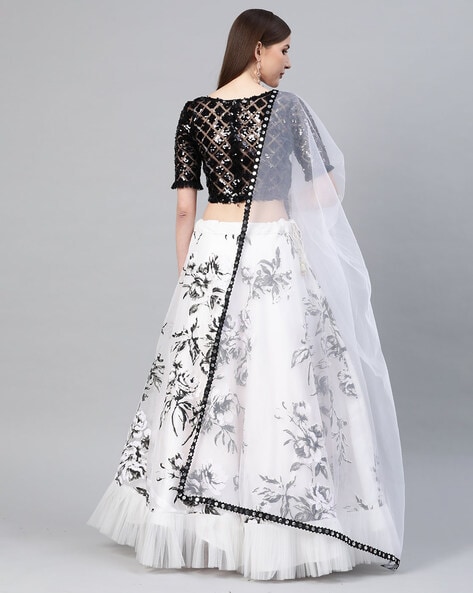 BLACK AND WHITE HARLEQUIN PRINTED LEHENGA SET WITH A HAND EMBROIDERED BLACK  BLOUSE PAIRED WITH A MATCHING DUPATTA AND SELF COLOURED DETAILS. - Seasons  India