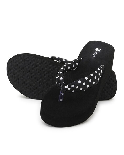 Black and white polka dot store flip flops