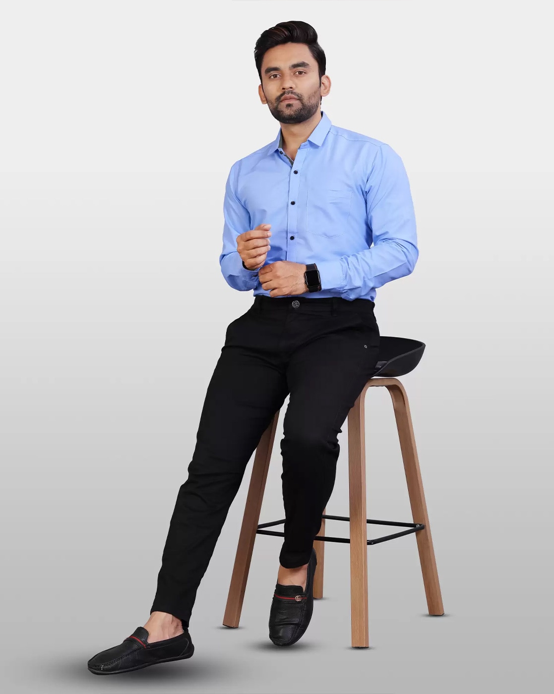a man in a blue shirt and black pants sitting on a couch. AI-Generated  33638404 Stock Photo at Vecteezy