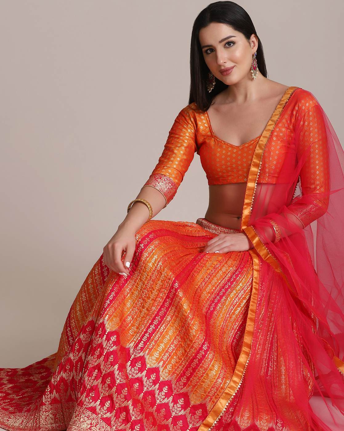 CORAL ORANGE SEQUIN 'ABLA' PATTERNED LEHENGA WITH AN 'ABLA' EMBROIDERED  BLOUSE PAIRED WITH A MATCHING SCALLOPED DUPATTA AND GOLD AND SILVER DETAILS  - Seasons India