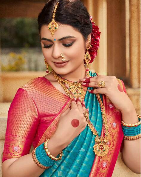 A typical South Indian look is certainly characterised by a glossy makeup,  stunning Kanjeevaram saree complemented with heavy temple jewe... |  Instagram