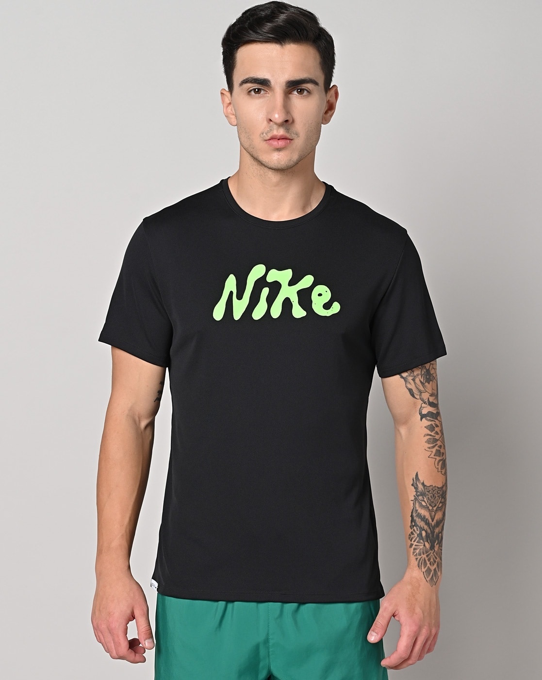 Black nike shirt shop with green swoosh