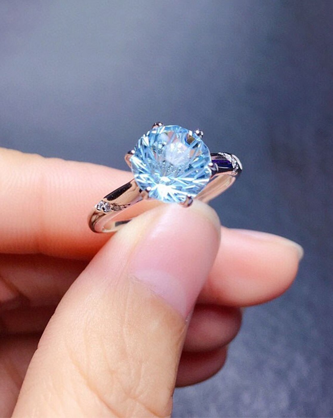 Blue sapphire diamond ring on female hand engagement finger Stock Photo -  Alamy