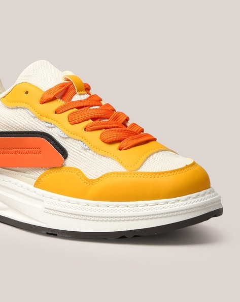 Orange and store yellow sneakers