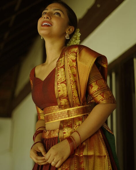 IZAH Designs - Cutie Ms Anjana in a traditional lehenga by Izah Designs for  her engagement..!!! Brocade weaving flaired skirt paired with a heavily  handworked croptop in antique gold tone bead embellishments.