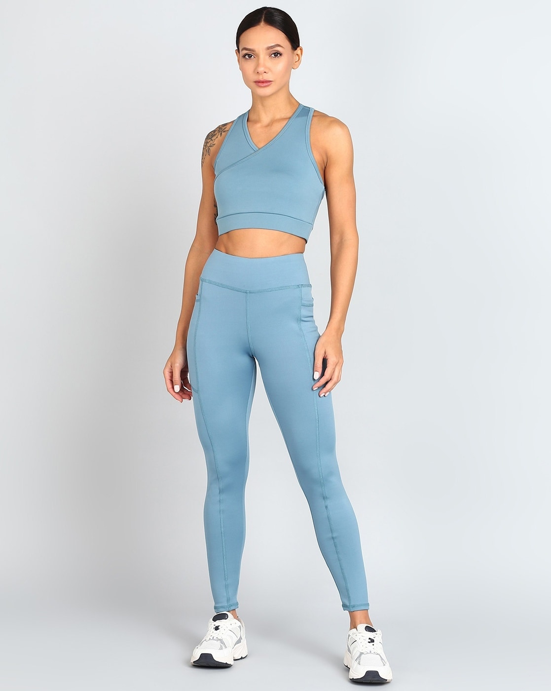 Woman in Teal Sports Bra and Brown Leggings · Free Stock Photo