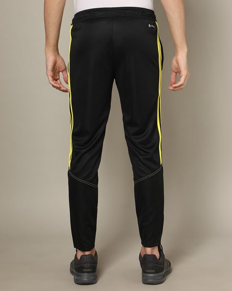 Black adidas pants with cheap yellow stripes