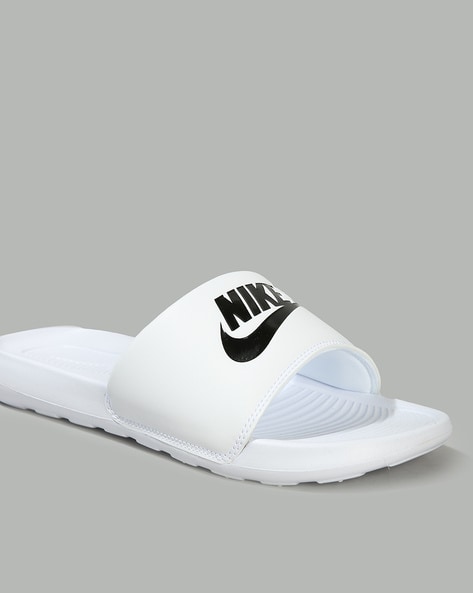 White and 2025 black nike slides