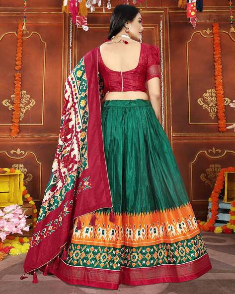 Mint green lehenga embellished with gold thread work, illusion neck choli  and coral orange dupatta. | Indian reception outfit, Reception outfits,  Western lehenga