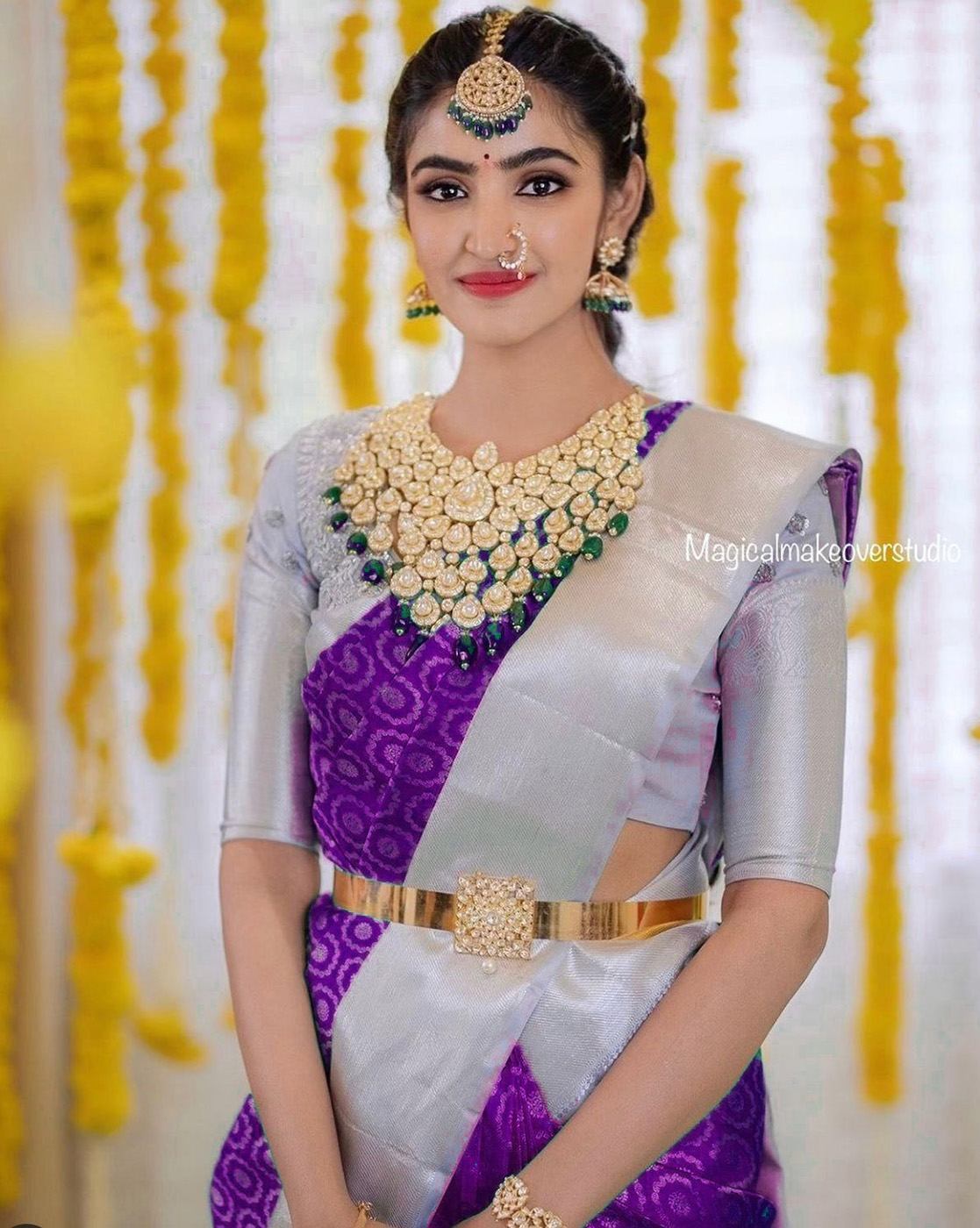 Please suggest some jewellery options that would go with this kanchipuram  silk sari for my brother's wedding. The sari is double shade in dark blue  and violet with silver silk border :