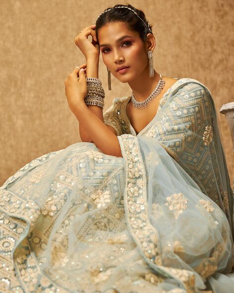 Photo of Light blue and white lehenga with contrasting blue necklace