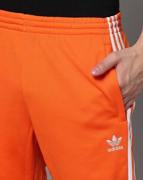 adidas sst track pants orange