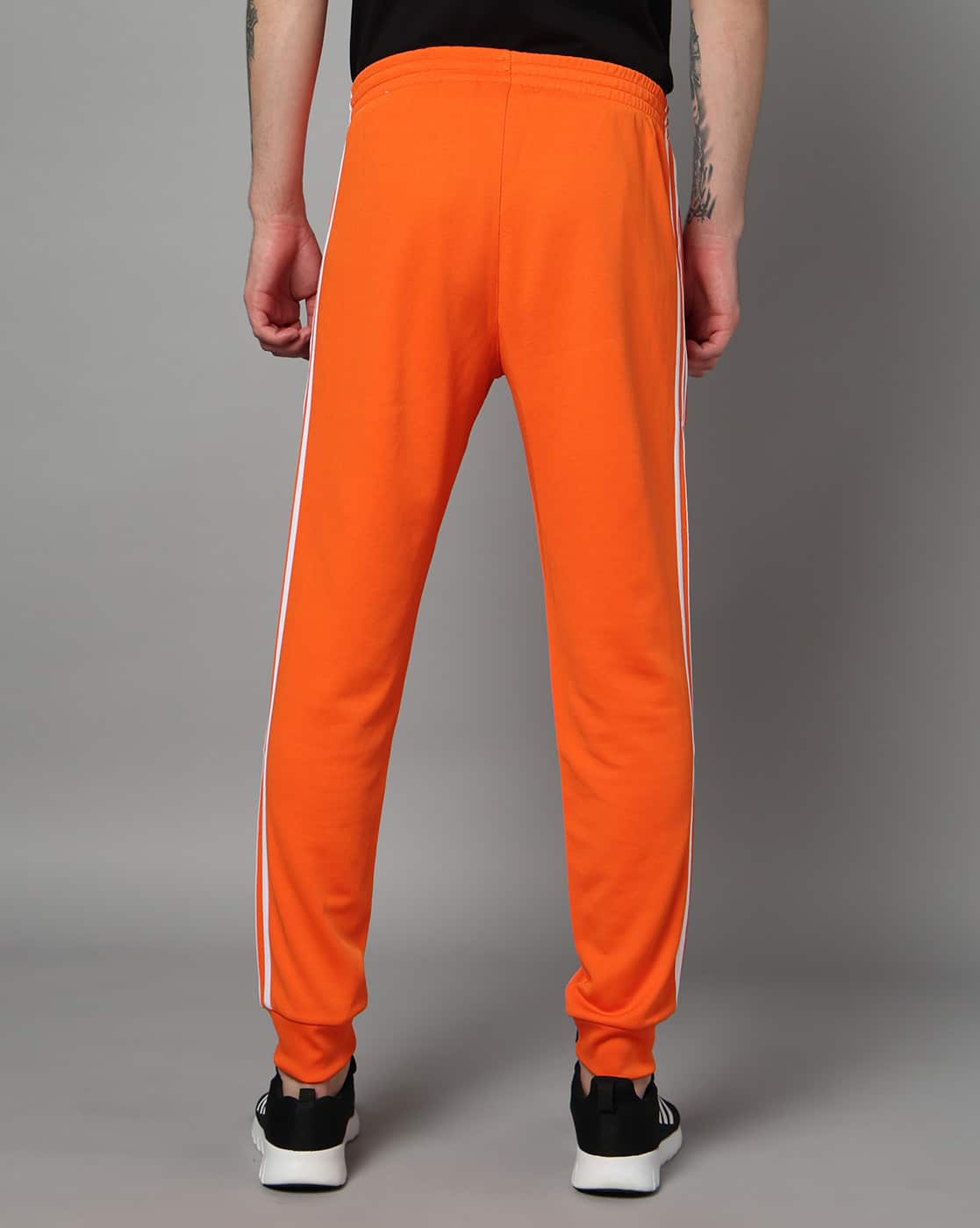 adidas sst track pants orange