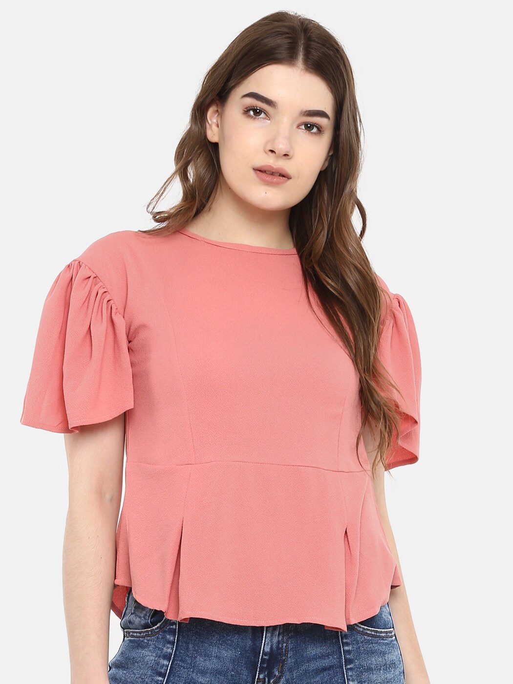 peach color top with jeans