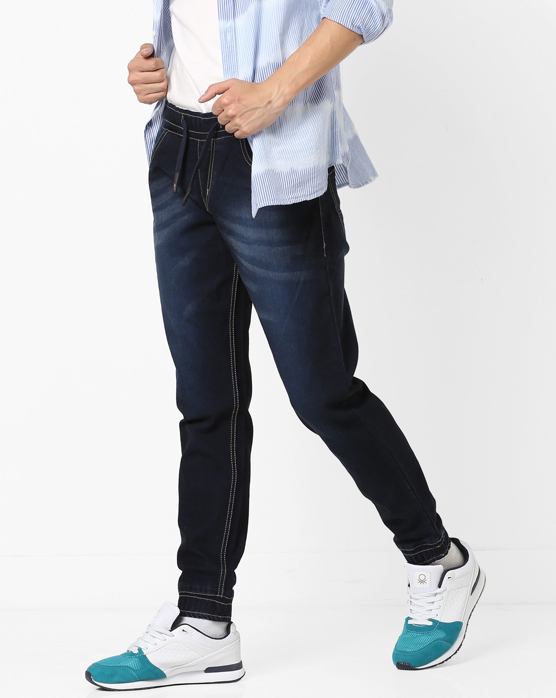 For 900/-(70% Off) Mid-Washed Jogger Jeans with Whiskers at Ajio