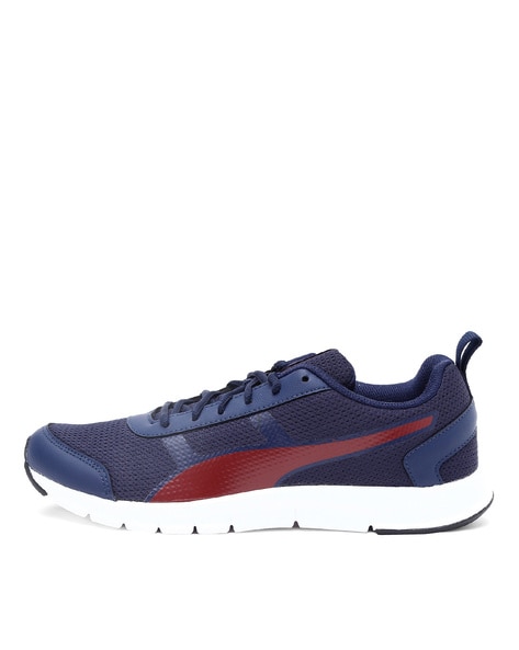 navy blue and orange pumas